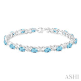 7x5  MM Oval Cut Blue Topaz and 1/20 Ctw Round Cut Diamond Fashion Bracelet in Sterling Silver