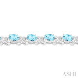 7x5  MM Oval Cut Blue Topaz and 1/20 Ctw Round Cut Diamond Fashion Bracelet in Sterling Silver